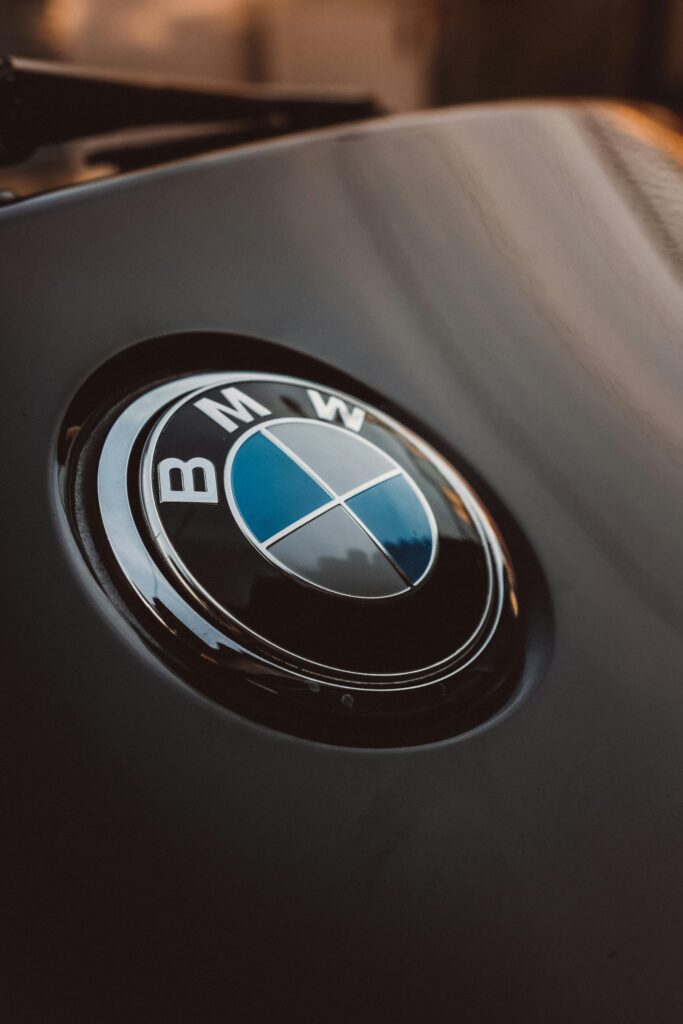 Close-up of a shiny BMW logo on a luxury car, emphasizing modern design. Content Markit